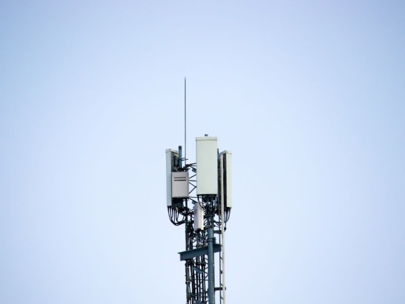 A cellphone tower with a bright blue backround