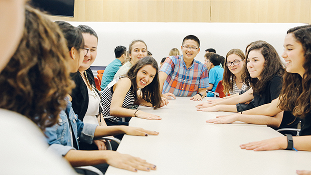 A group of students play a game at a table