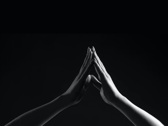 Black and white image of two hands touching 
