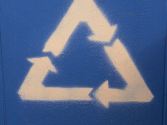 White triangle recycle symbol on blue background