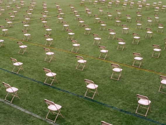 Chairs on a lawn spread out to encourage physical distancing