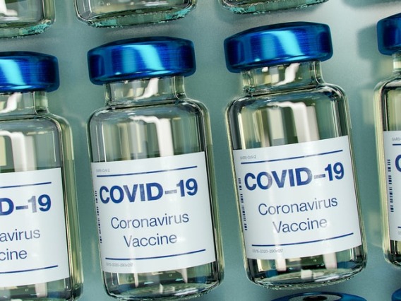 One row of COVID 19 Vaccine bottles