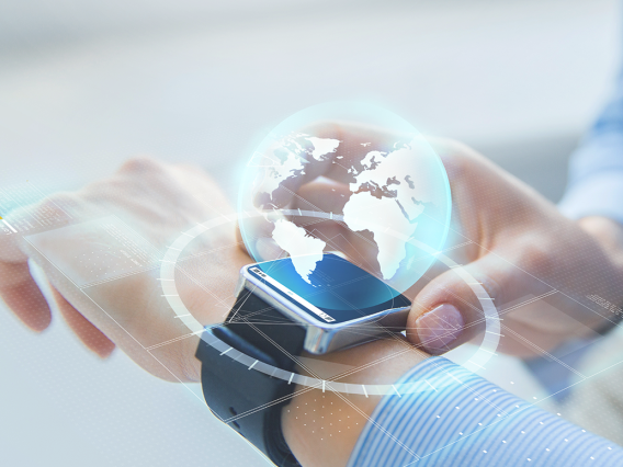a holograph of the earth hovers above a smart watch on a person's wrist