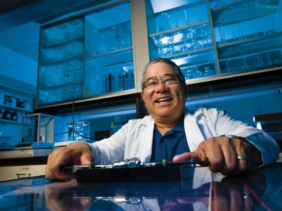 Researcher smiling in a lab.