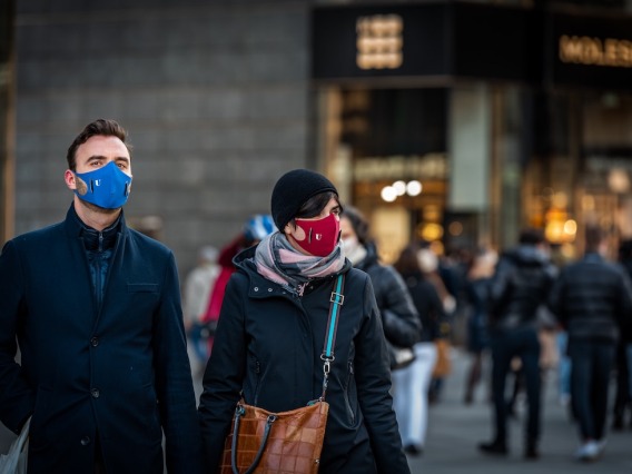 Man and Woman wearing masks outdoors