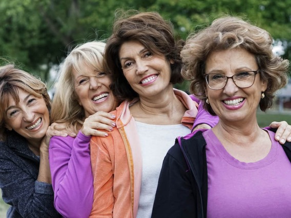 4 women smiling.