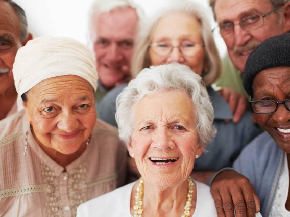 Group of elderly people smiling.