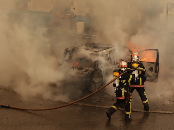 Firefighters fighting car fire