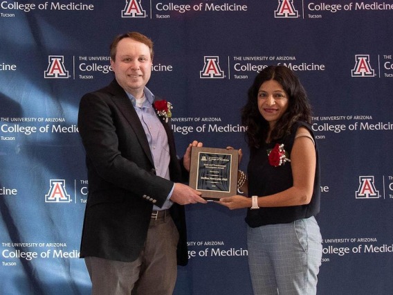 Dr. Shroff (right) presents the Clinical Investigator Award to Dr. Steffan Nawrocki.