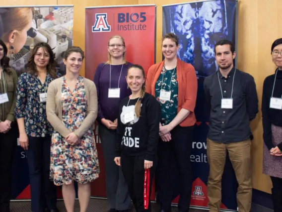 Group of people pose in front of BIO5 Institute signs