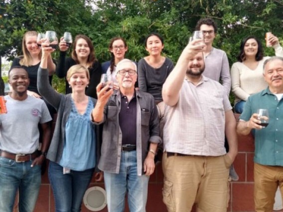 Group of people raise their glasses in celebration