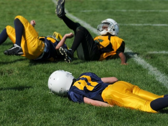 Football players falling on the ground