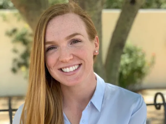 Young woman with long blonde hair and a blue collared shirt