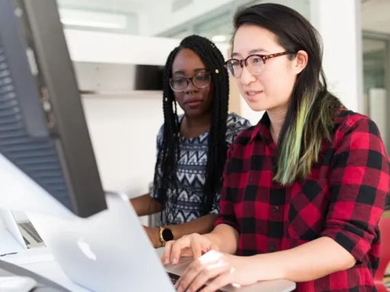 Two women working at a computer