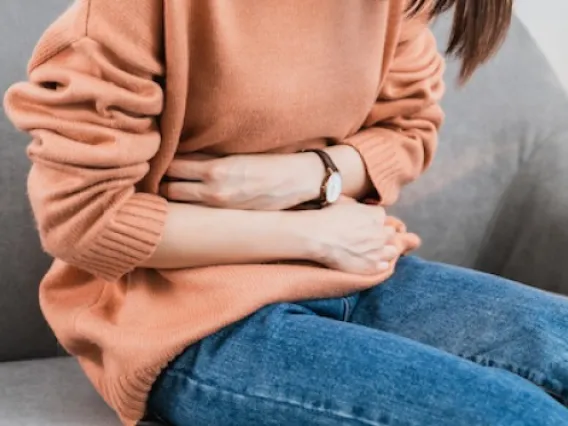 Woman holding her stomach in pain