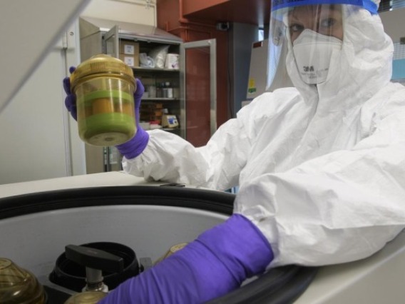 Scientist in full protective gear working during the pandemic