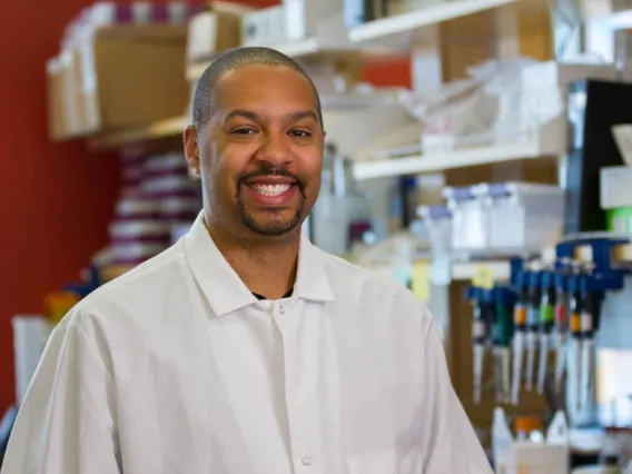 Man in a white lab coat in a lab