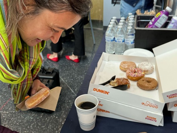 Researcher enjoying doughnuts at Meet Your Neighbor