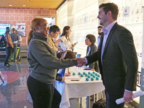 Young people shaking hands at a student and industry networking event at the BIO5 Institute