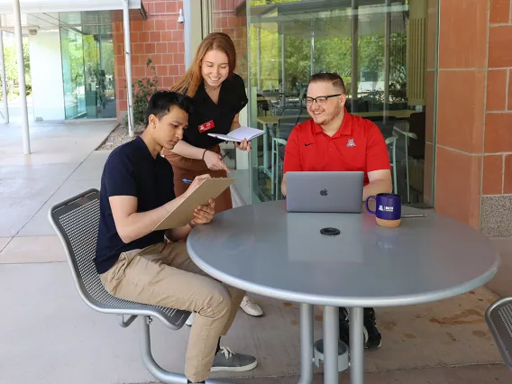 A group of students working together outside 