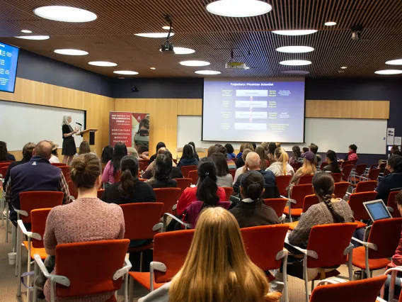 an audience of people watching a panel discussion