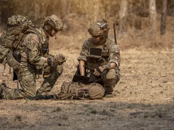 Military men camoflauged in a field