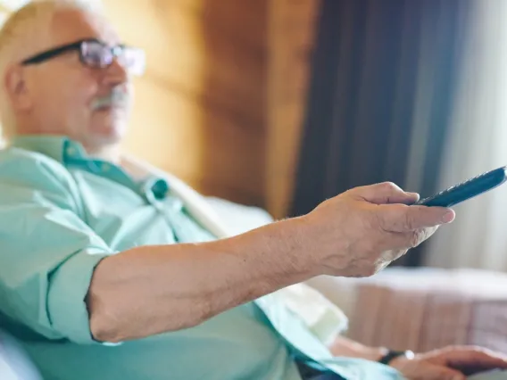 Older man watching TV