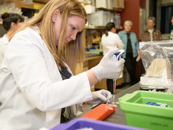 A woman pipetting in a research lab