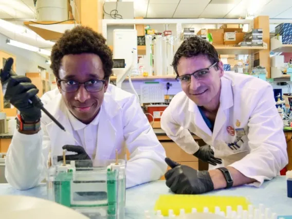 Sam Campos works with his student at his lab in the BIO5 Institute