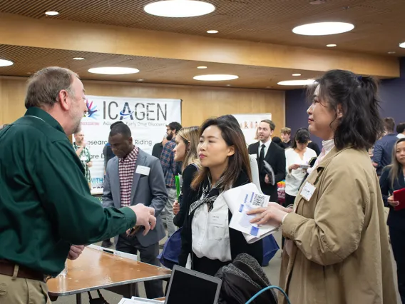 A group of students talking to people for industry
