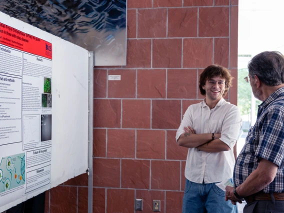Two individuals discussing a scientific poster at a conference held at the BIO5 Institute