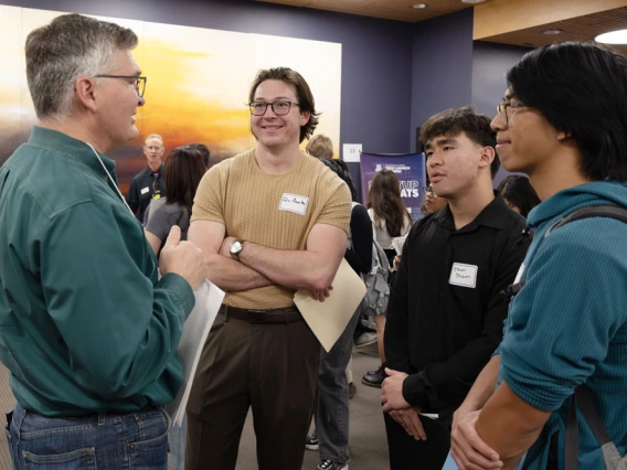 Three people talking at a networking event at the BIO5 Institute