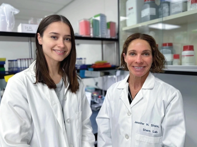 Two researchers in lab coats smiling in a laboratory, with shelves stocked with lab supplies in the background. 