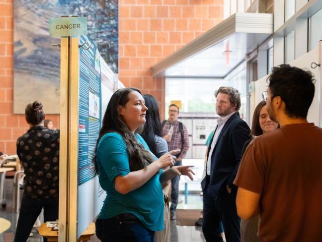 A group of people presenting scientific posters