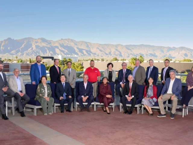 A group of people smiling in an outside background