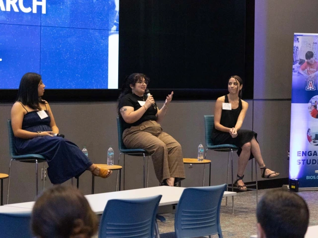 Group of panelists presenting at the front of the room