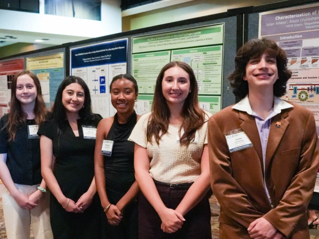 Morgan Mollberg, Abrielle Anchondo-Leyva, Kadence Modica, Caroline Lasch, and Julian Amaya pose in front of their research posters at the Student Discovery Zone.