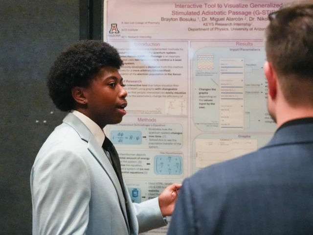 Brayton Bosuku showcases his research to an attendee of the AZBio Awards' Student Discovery Zone.