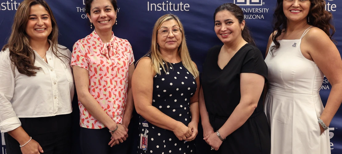 Group of women pose in front of the BIO5 Institute logo