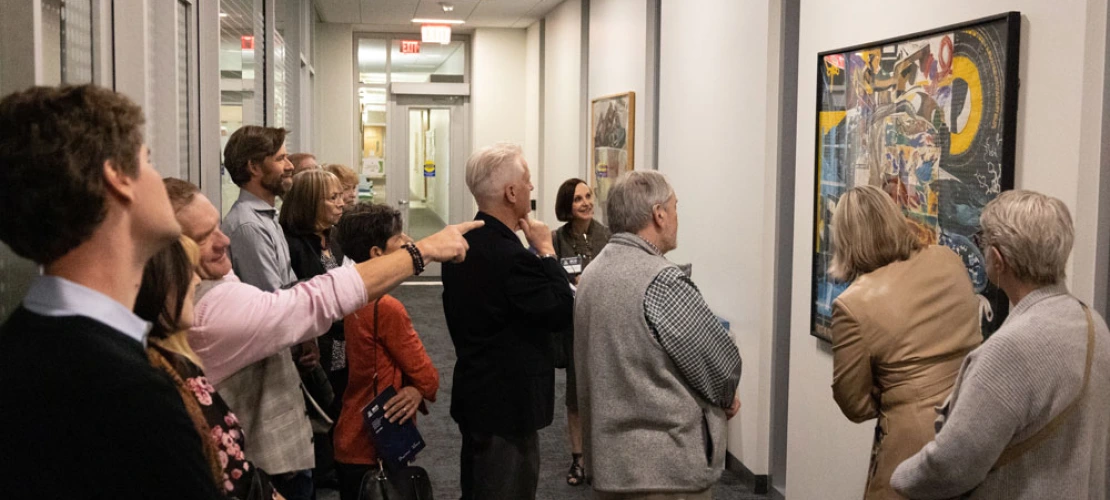 Group of people admiring Marvin Lowe artwork at the BIO5 Institute