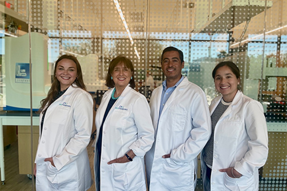 Group of scientists in lab coats posing for a picture