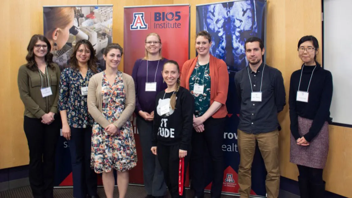 Group of people pose in front of BIO5 Institute signs