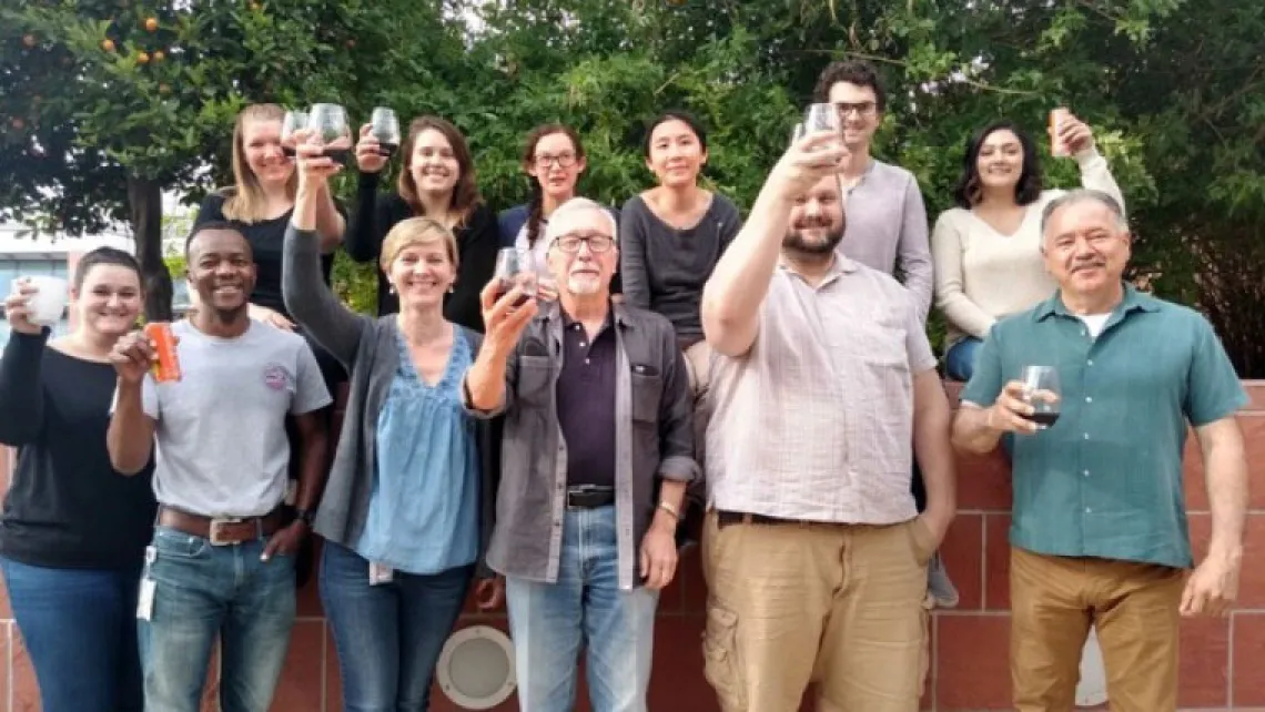 Group of people raise their glasses in celebration