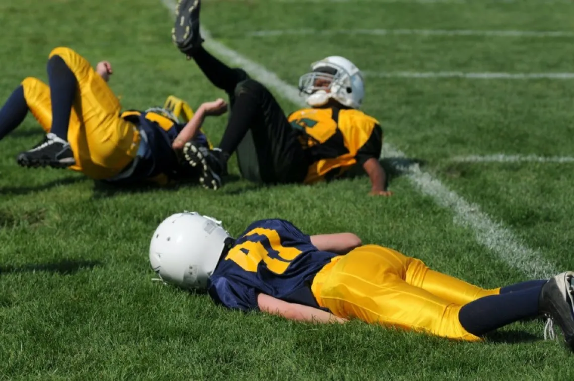 Football players falling on the ground