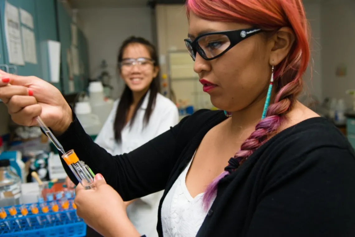 Young woman pipetting as part of the KEYS Research Internship