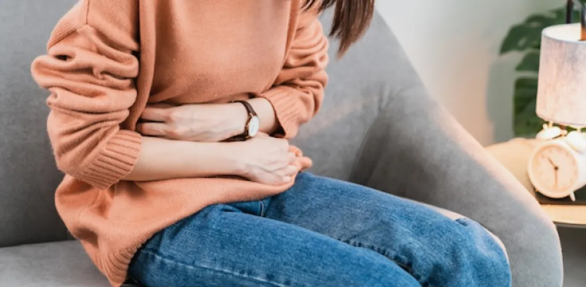 Woman holding her stomach in pain