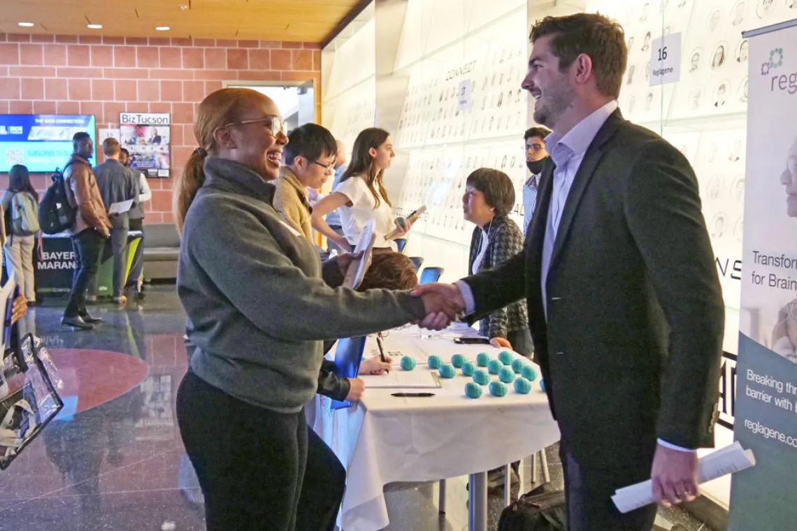 Young people shaking hands at a student and industry networking event at the BIO5 Institute