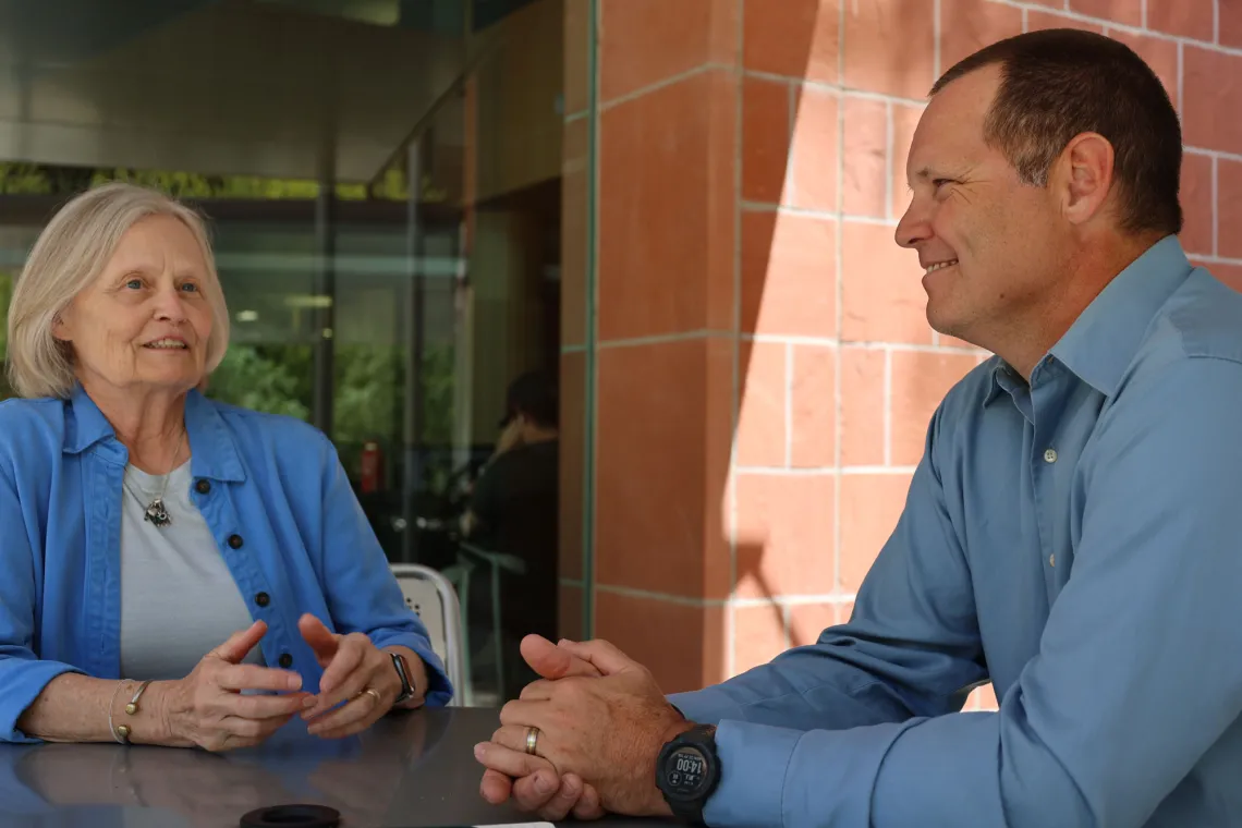 Susan and Chris Frost discuss research in front of the BIO5 Institute