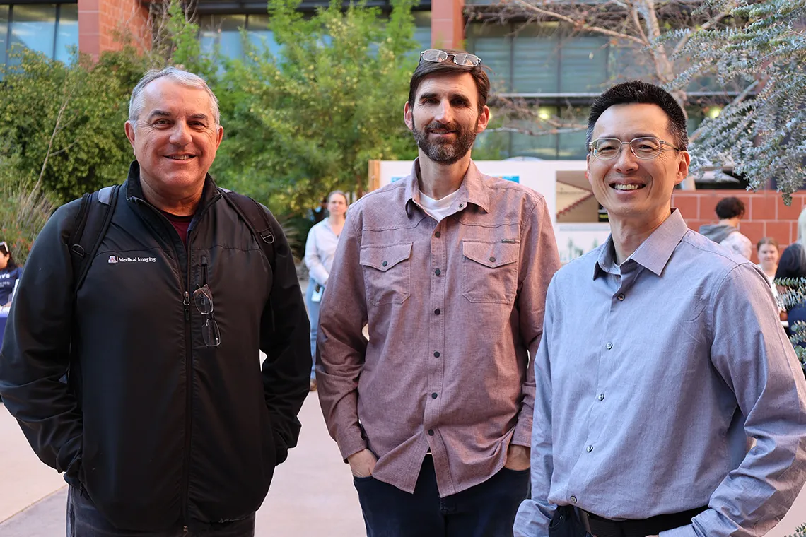 a group of men posing for the camera