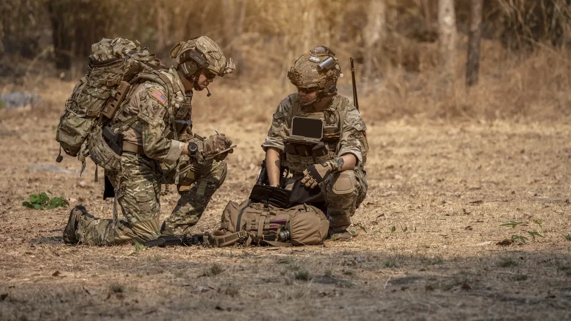 Military men camoflauged in a field